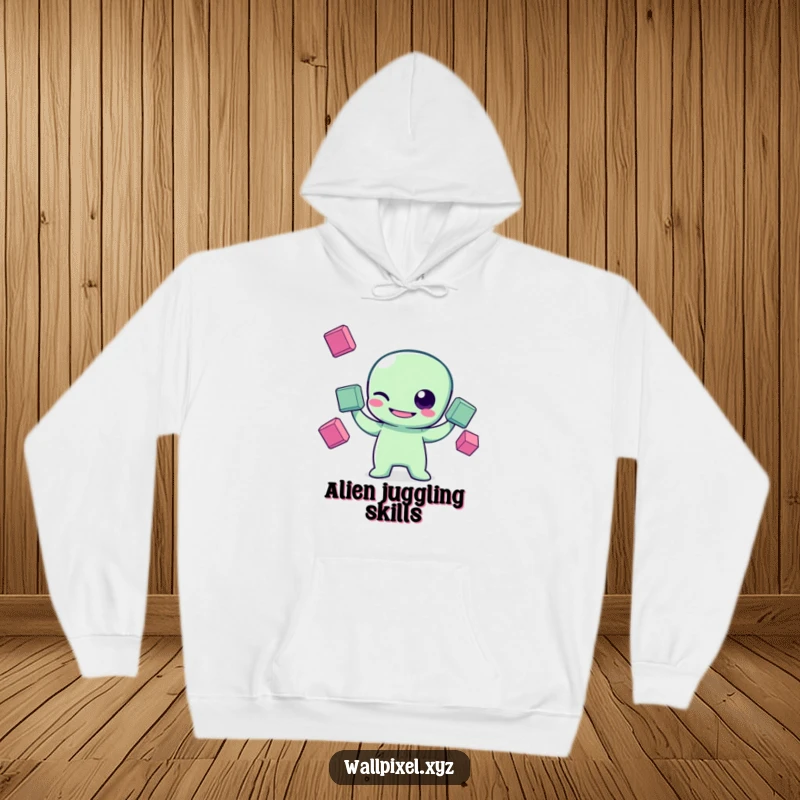 Funny pixel art hoodie with a grinning pixelated alien character winking while juggling three floating squares, ideal for retro sci-fi fans.