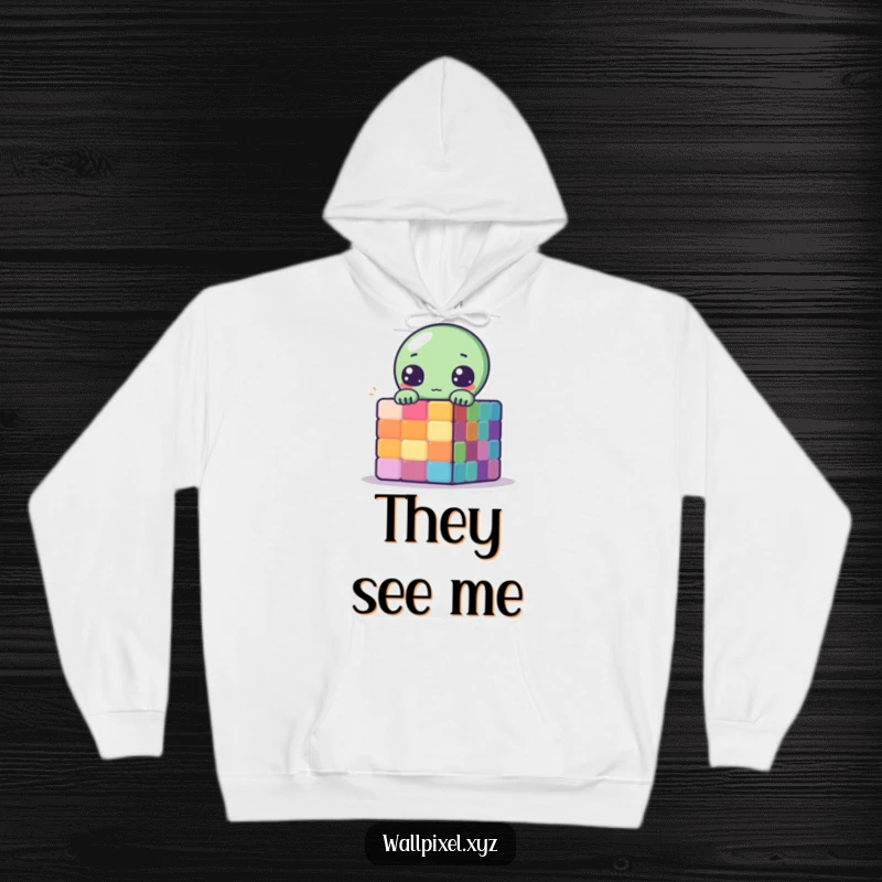 Funny Pixelated Alien Hoodie showing a cute alien peeking from behind a colorful pixelated cube in retro style.