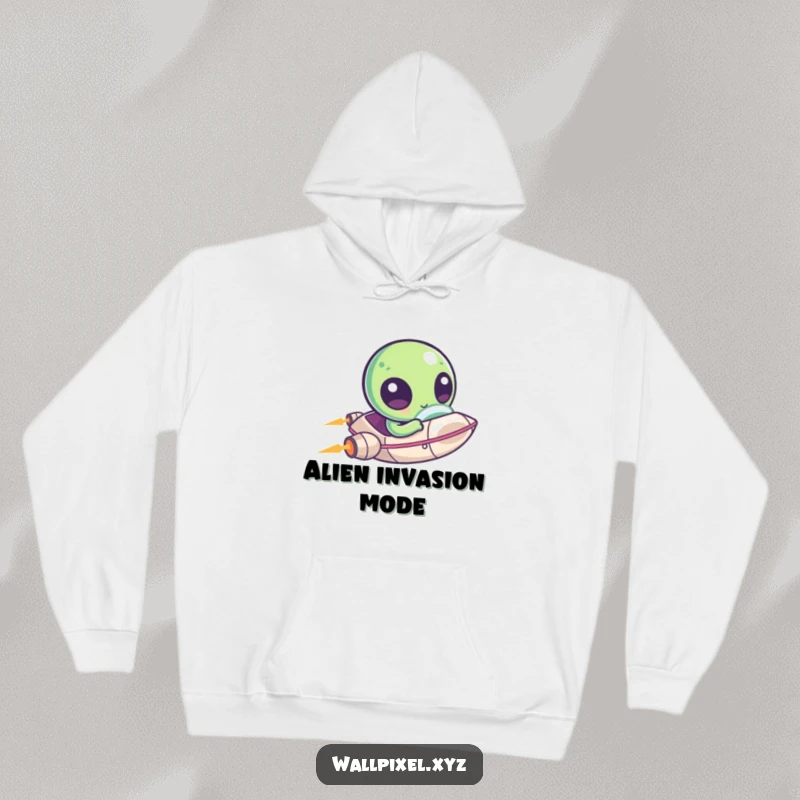 Funny hoodie depicting a kawaii pixelated alien with large eyes zipping around in a small spaceship, offering cozy cosmic charm.