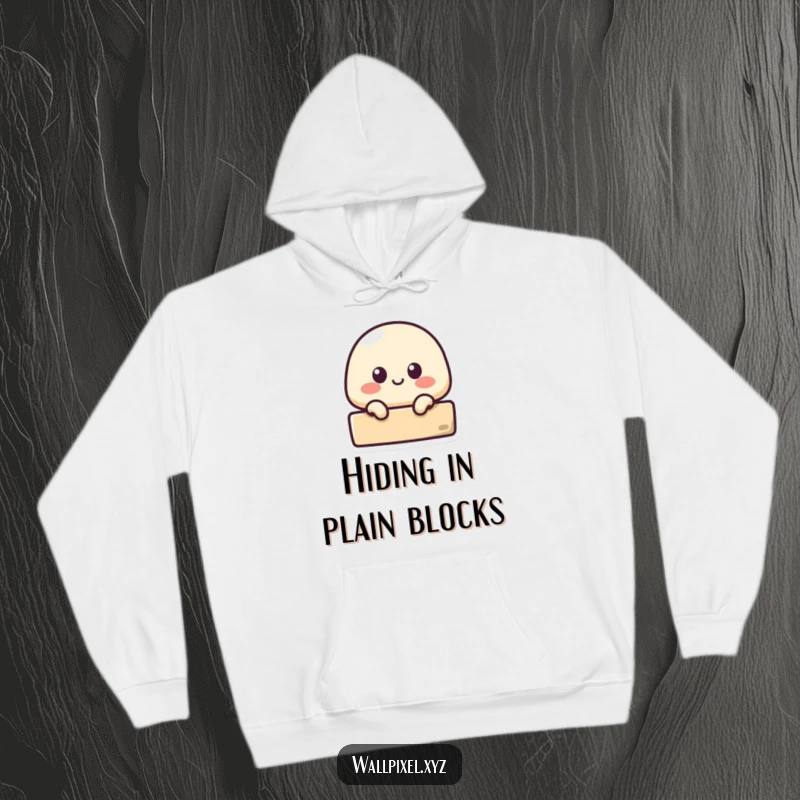 Funny hoodie with a small pixelated blob character peeking from behind a block, offering warm, humorous retro vibes.