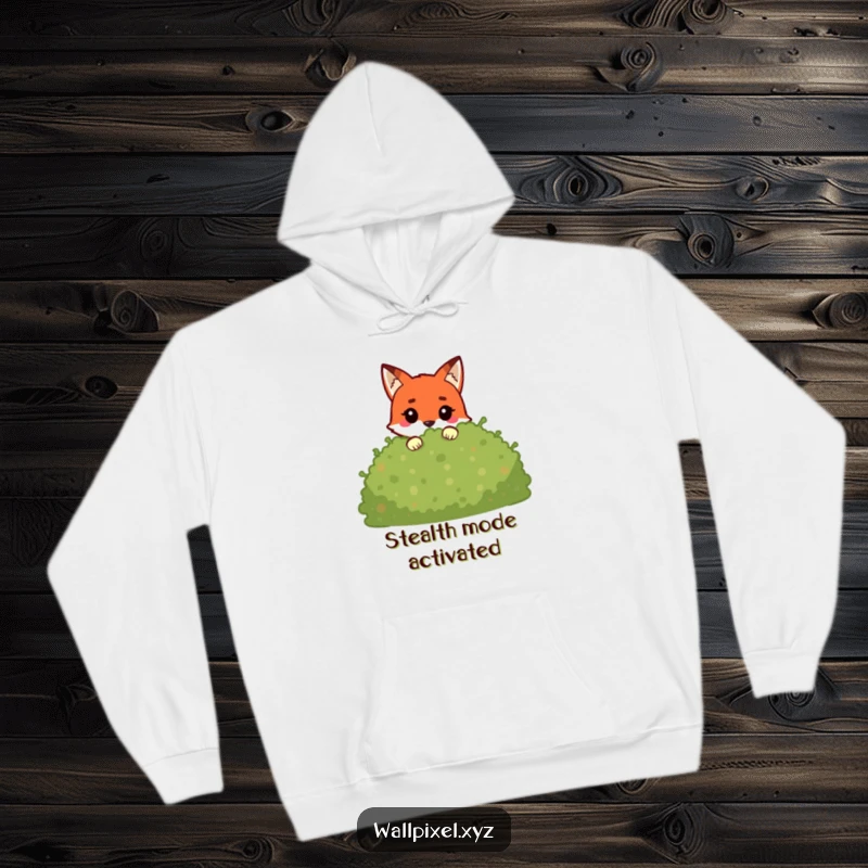 Funny pixel fox hoodie featuring a cute blocky character peeking from behind a pixelated bush, perfect for cozy gaming sessions.
